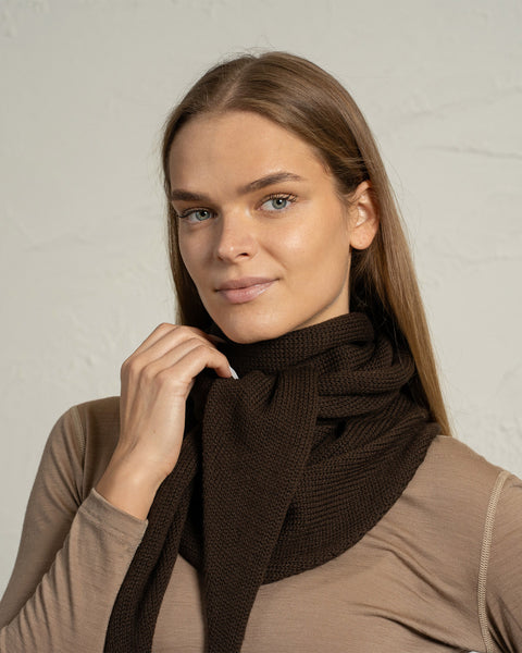 Close-up of brown merino knit bandana scarf wrapped around the neck.