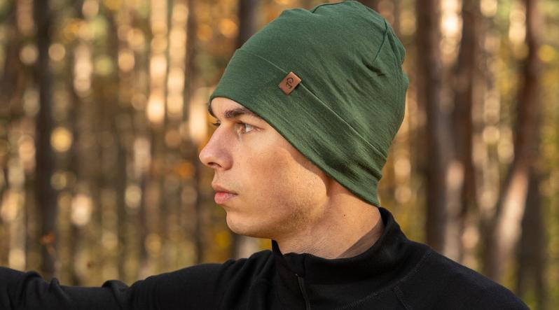 Man outdoors wearing dark green merino wool beanie