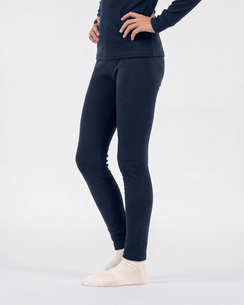 A person modeling navy blue thermal leggings and light-colored socks, shown from the waist down.