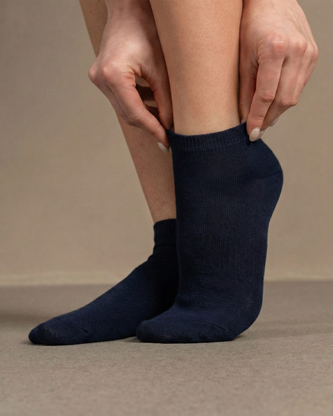 Blue bamboo ankle socks worn on feet, soft breathable socks for everyday comfort