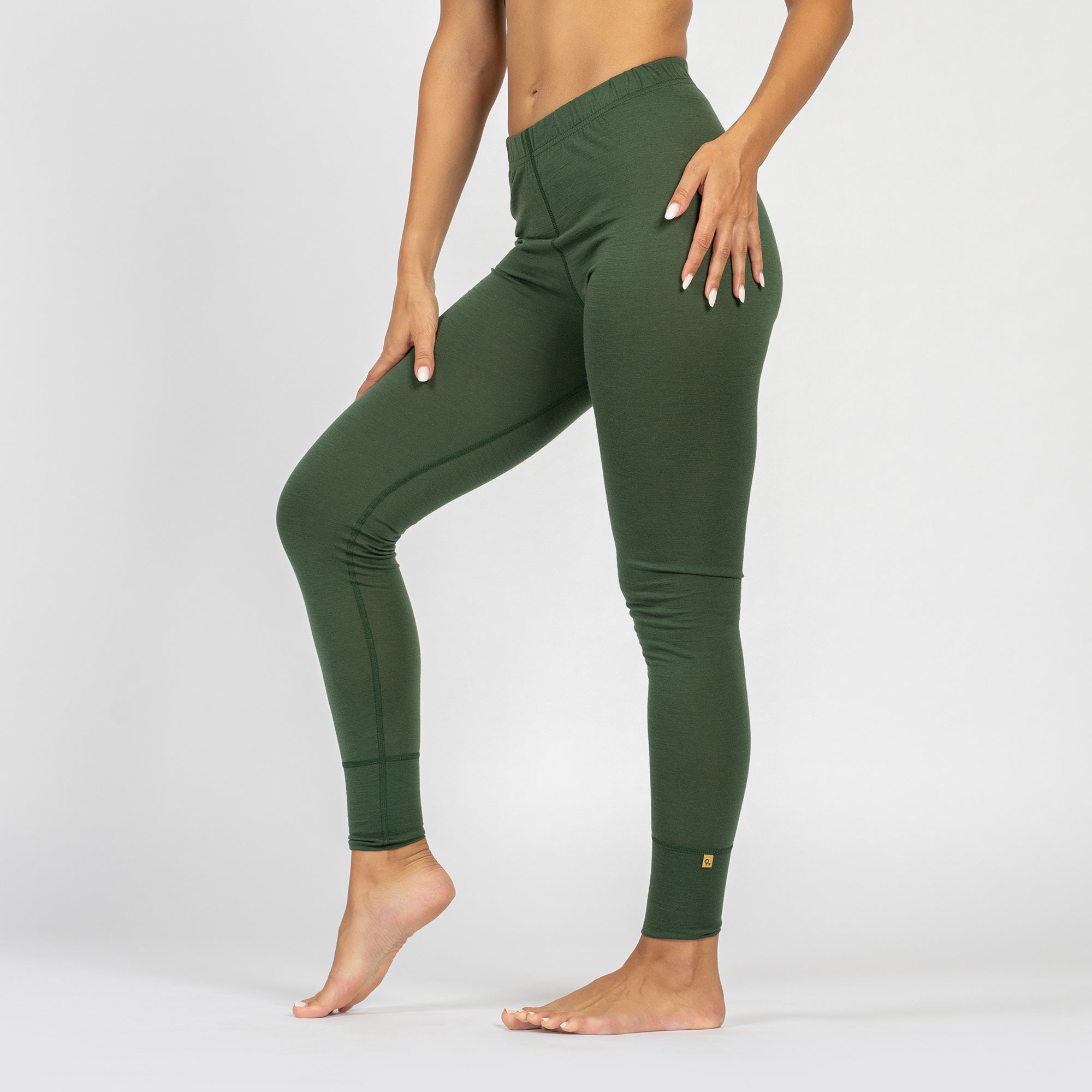 Women’s dark green merino wool thermal leggings, side view.