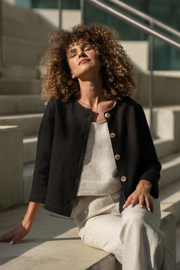 Woman with curly hair wearing natural linen jacket Alice