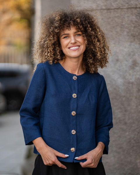 Woman with curly hair wearing storm blue linen jacket Alice