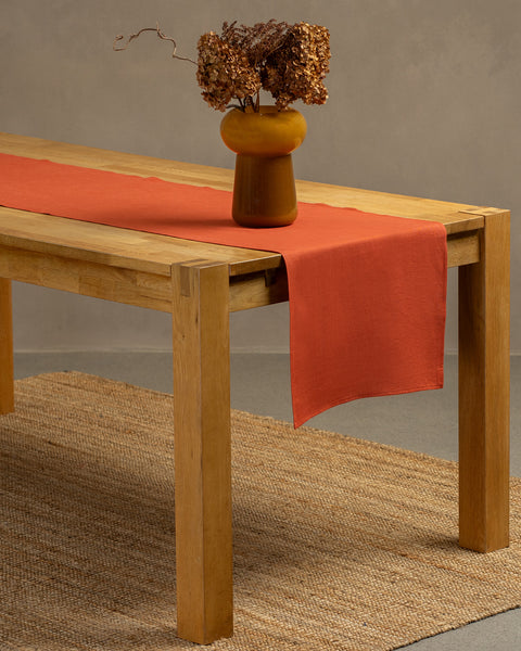The menique cinnamon red linen table runner.