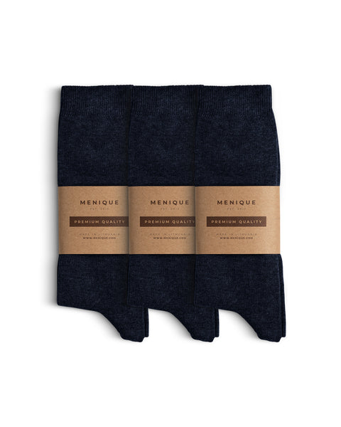 Three pairs of dark blue men’s cotton socks arranged side by side with Menique brown paper labels marked ‘Premium Quality.