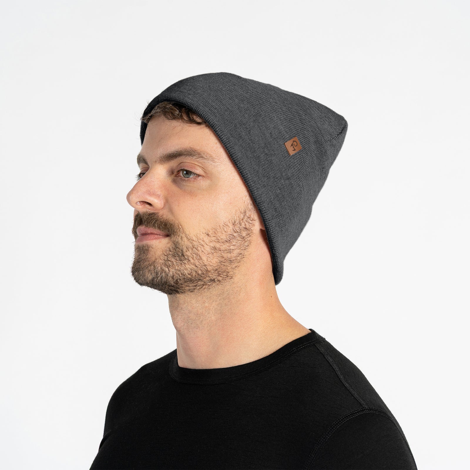 Dark gray knit beanie and gloves set on a white background