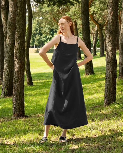 A woman wearing 100% Linen Maxi Strap Dress Jasmine in the color pure black. 