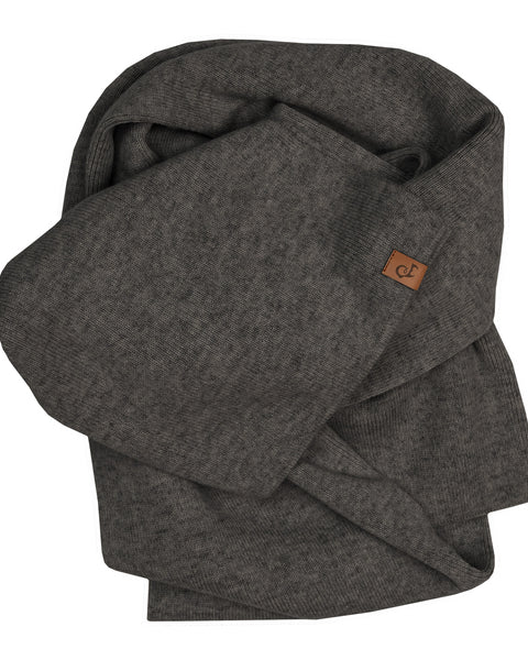 A dark charcoal grey knitted scarf, casually folded and bundled against a pure white background. A small, square brown leather logo patch is visible on one of the folded edges.