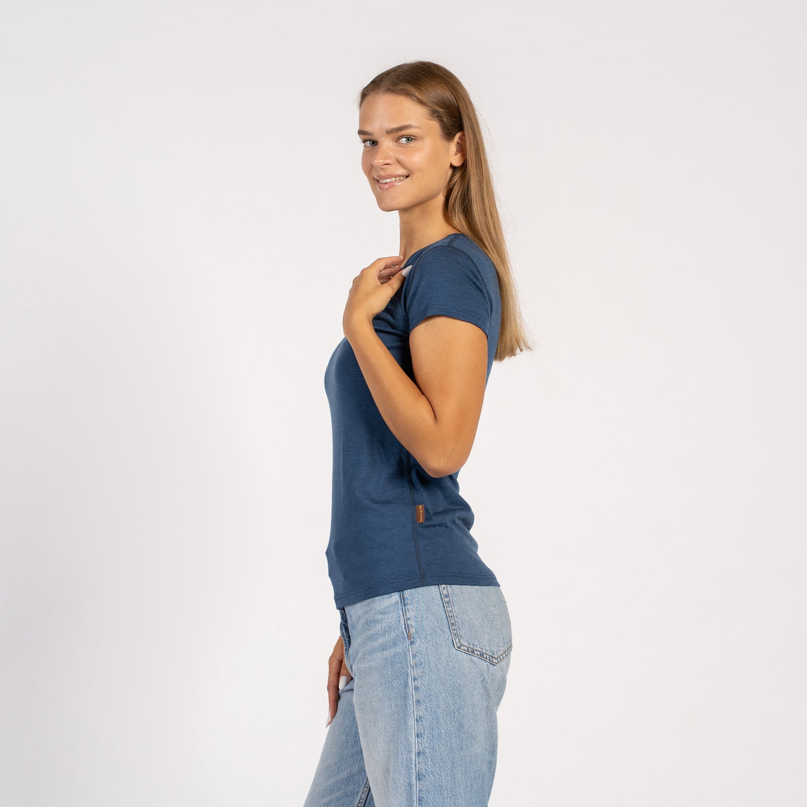 Woman smiling in a denim blue Merino wool V-neck short sleeve T-shirt.