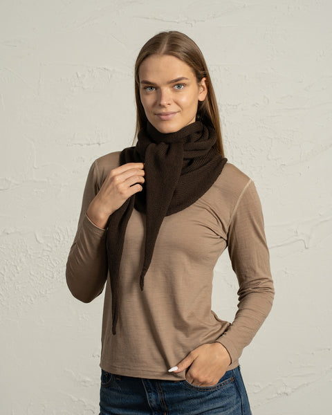 Woman wearing brown merino wool knit bandana scarf wrapped around the neck.