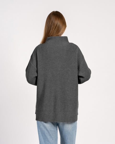 Back view of dark gray oversized merino wool knit sweater with ribbed hem and collar.
