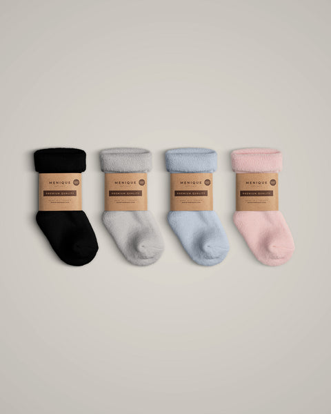 The menique kids&#39; merino wool sherpa lined socks in all available colors, with packaging.
