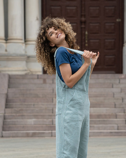 Gorgeous woman in a city, wearing mint green linen Jumpsuit Nicci.